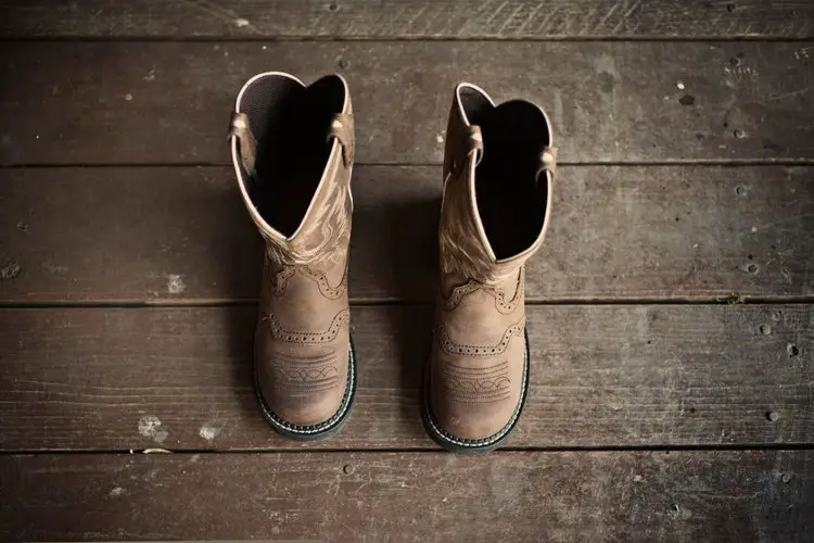 a pair of cowboy boots on the wooden floor