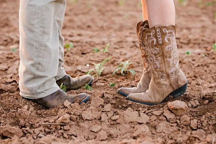 man and woman wears cowboy boots standing on the ground
