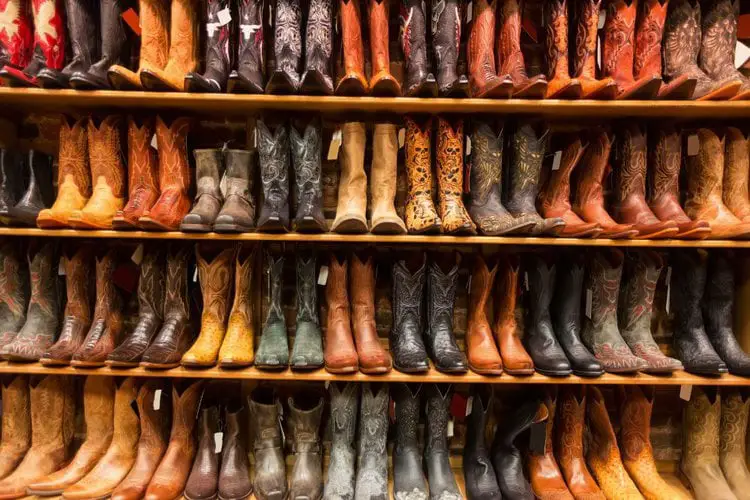 Many pairs of cowboy boots in the store