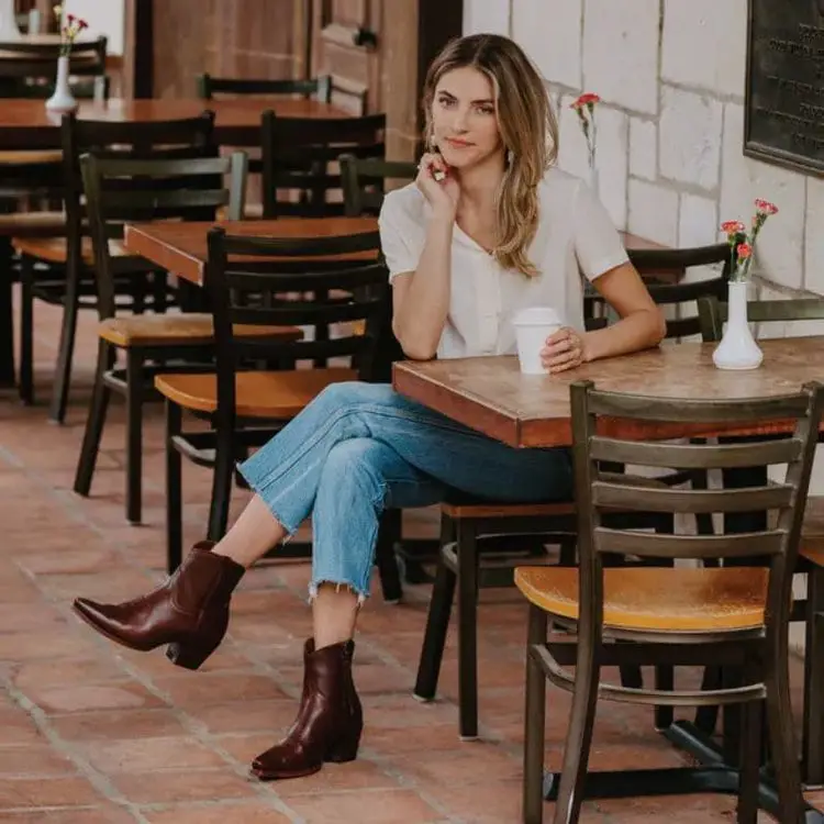 Girl wears The Daisy boots from Tecovas