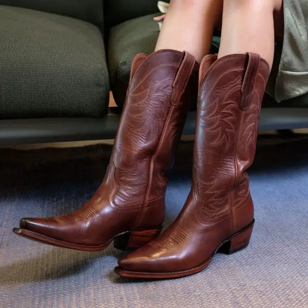 Women wear The Annie Cowboy Boots and are sitting on the sofa