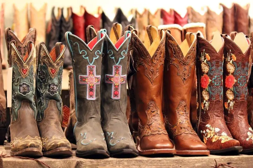 many pairs of cowboy boots on the floor