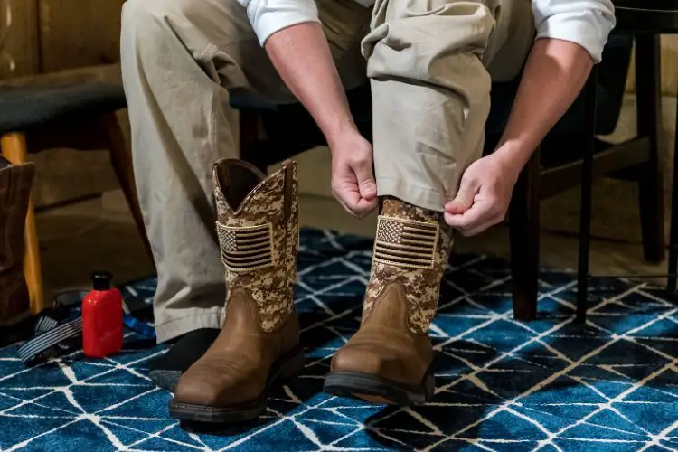 a man is putting on American flag cowboy boots