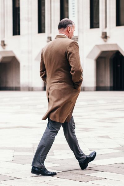 a man is walking on street