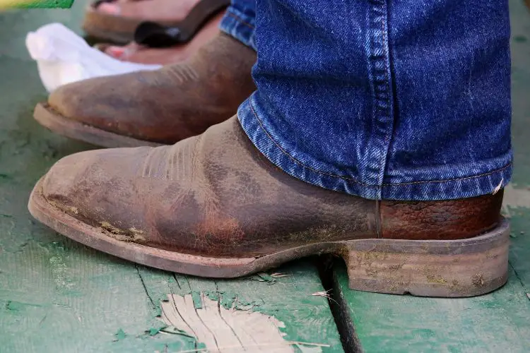cowboy boots with dry mud