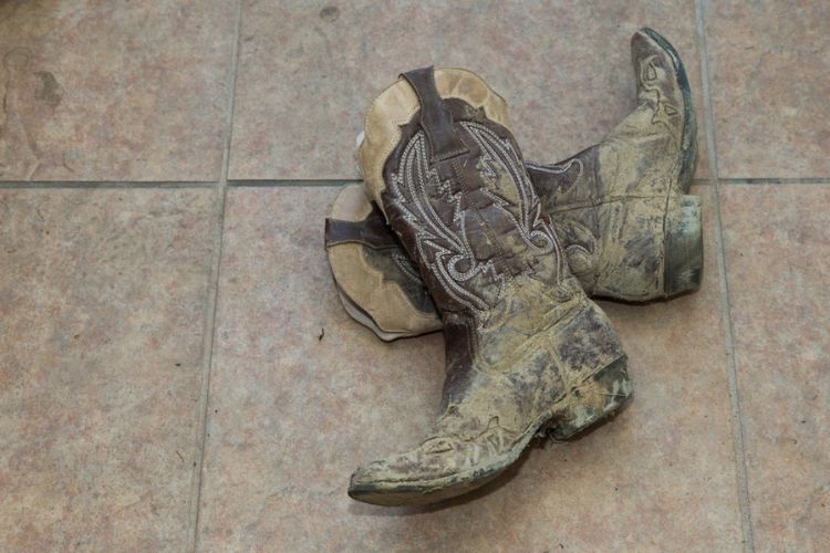 dry mud covers cowboy boots