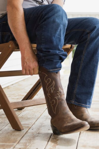man wears jeans and roper cowboy boots