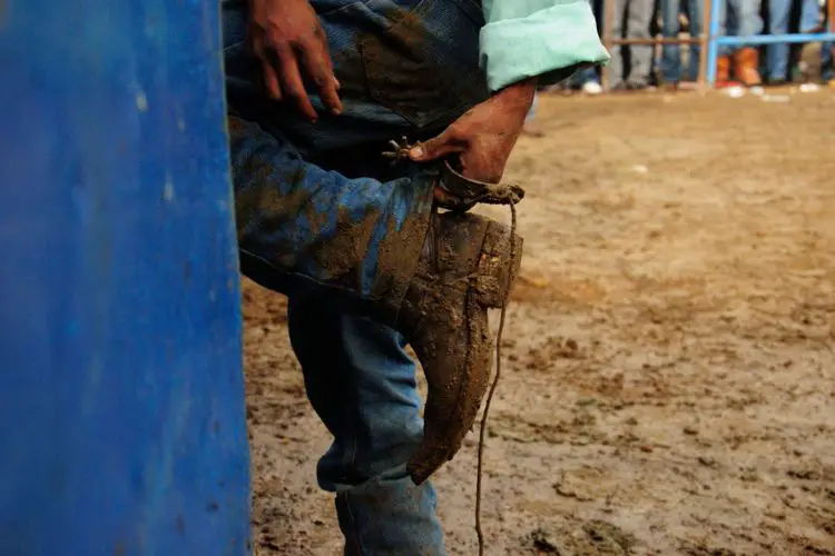 man with muddy cowboy boots