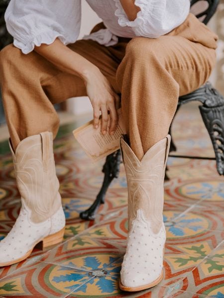 A woman wears The Jessie white ostrich cowboy boots