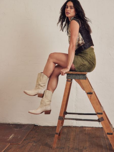A woman wears The Sadie Cowboy Boots
