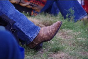 ripped jeans with cowboy boots