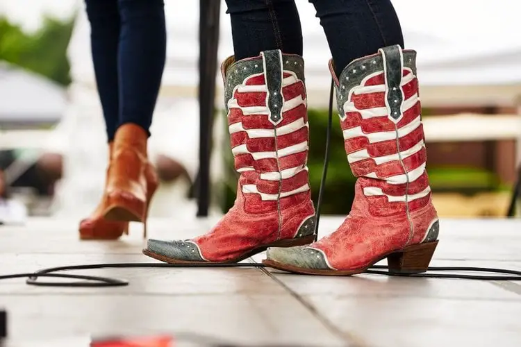 Women wear cowboy boots with flag motifs