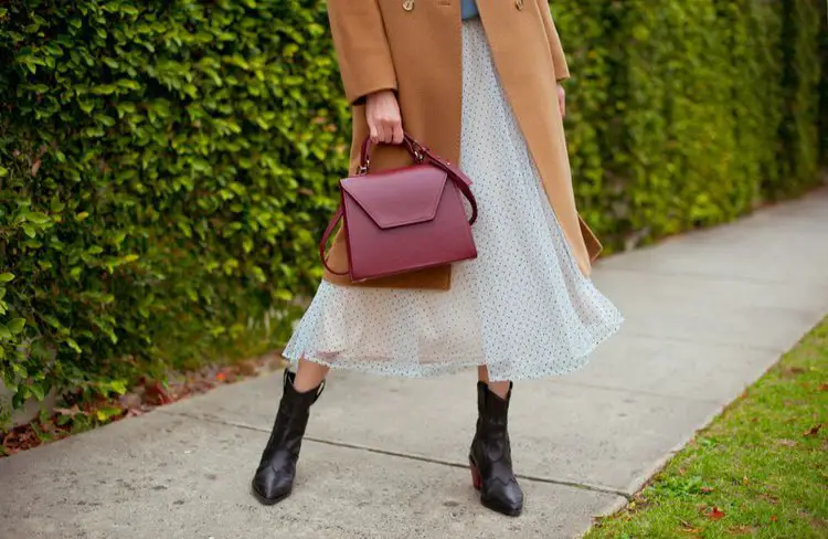 Women wear skirt with ankle cowboy boots