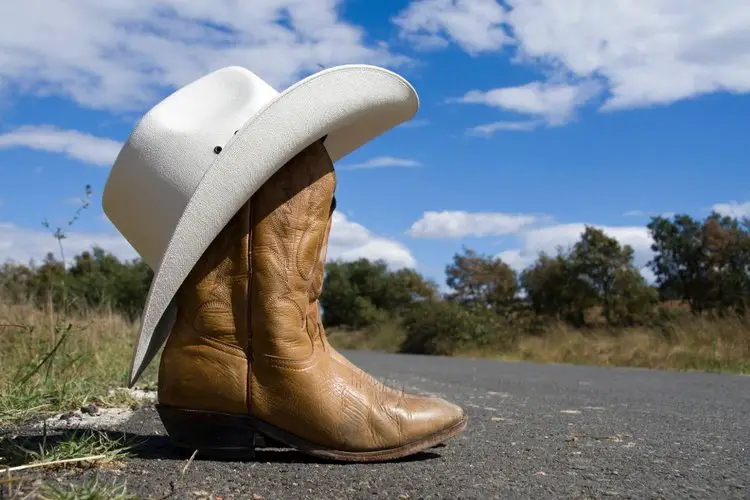 cowboy boots and cowboy hat on the road