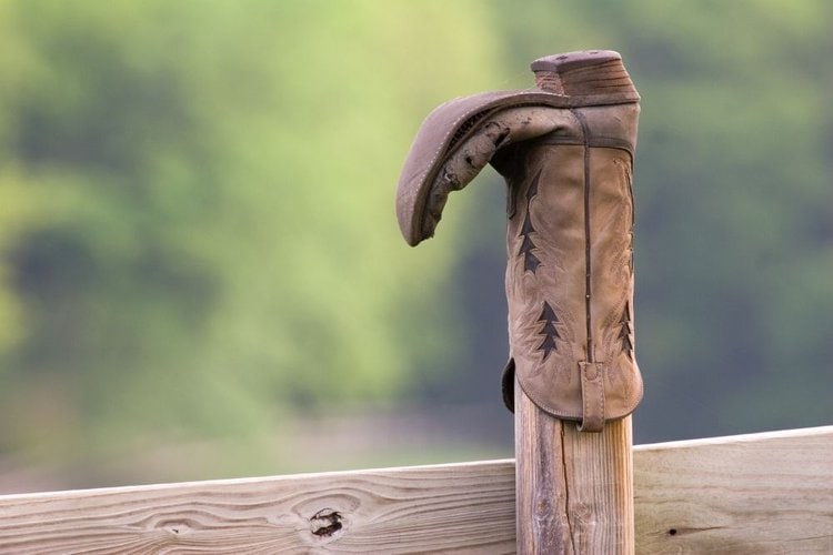 cowboy boots hook on the wood fence