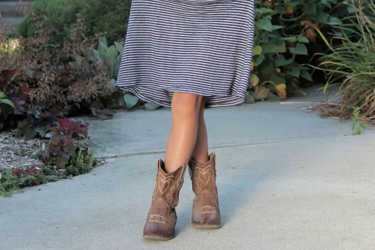 girl wears mini dress with cowboy boots