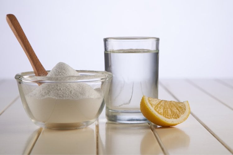 baking soda, vinegar, lemon on a table