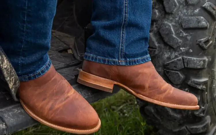 Man wearing The Earl Goat Boots sit on the Truck