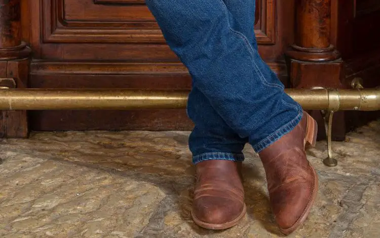 Man wearing The Earl Goat Boots with jeans stand on the floor