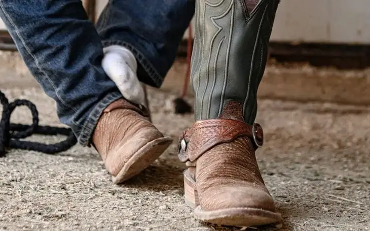 Man wearing The Prsescot Shark Cowboy boot is sitting down