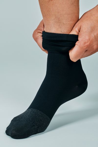 A man is folding a sock