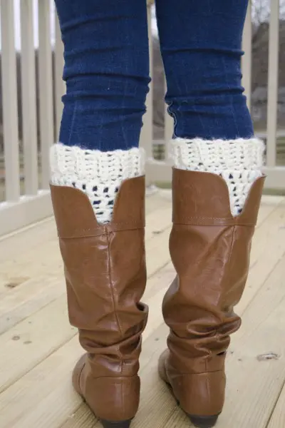 A woman wears boot cuffs with cowboy boots