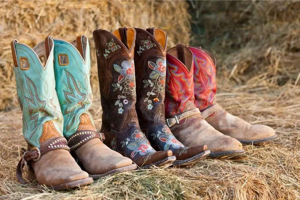 3 pair of cowboy boots on the ranch