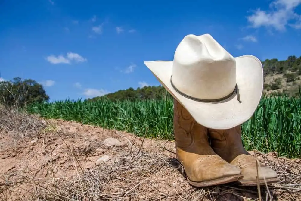 tan cowboy boots with hat for hiking