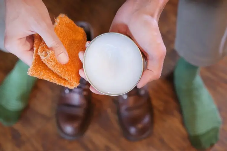 A man holding mink oil bottle