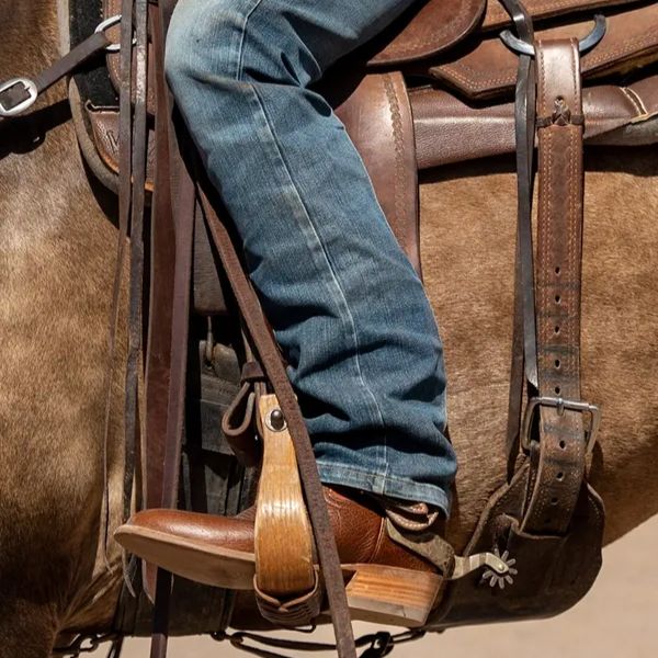 a man wears The Prescott boots from Tecovas for riding horse