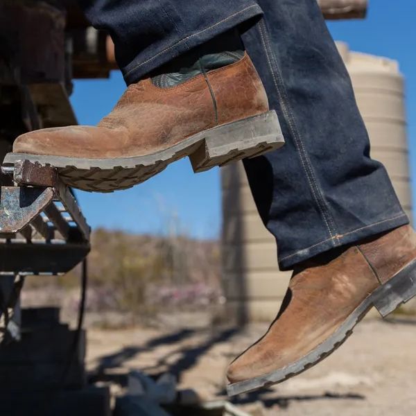 a man wears jeans and The Midland from Tecovas on the ranch