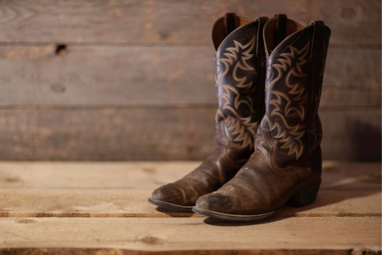 a brown pair of cowboy boots on the floor