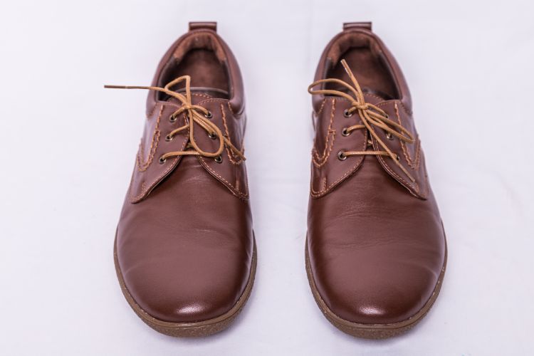a pair of brown Derby shoes