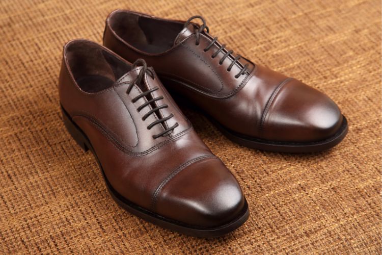 a pair of brown Oxfords shoes