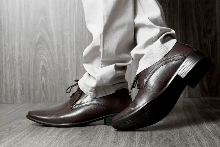 man wearing brown glossy fashionable dress shoes