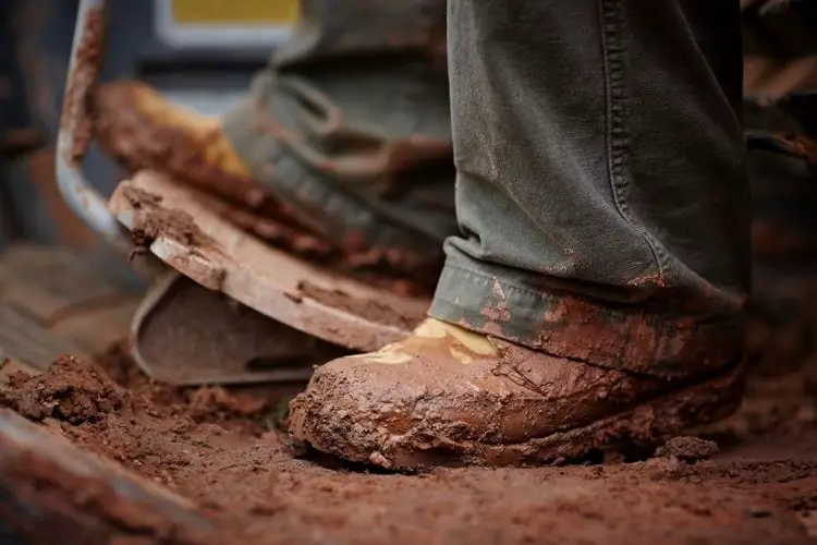 men wear muddy boots for driving