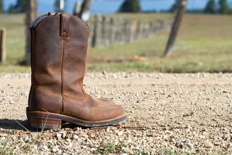 a pair of western boots on the gravel road