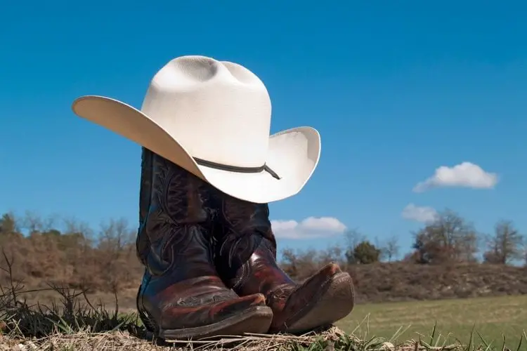 distressed cowboy boots on the road