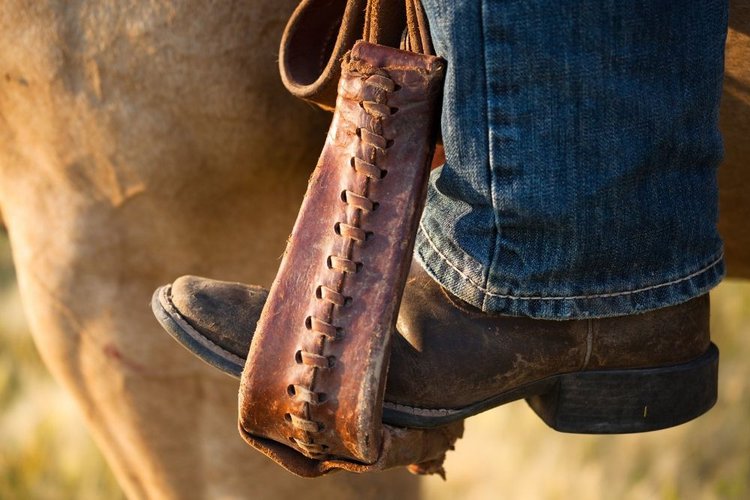 men wear cowboy boots to riding a horse