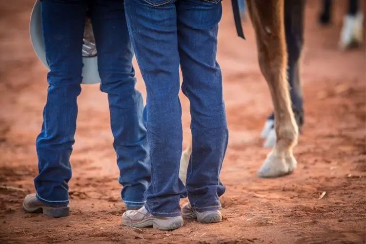 Bootcut jeans with cowboy boots on the ground