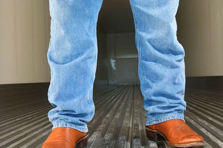 Loose fit bootcut jeans with reddish yellow cowboy boots