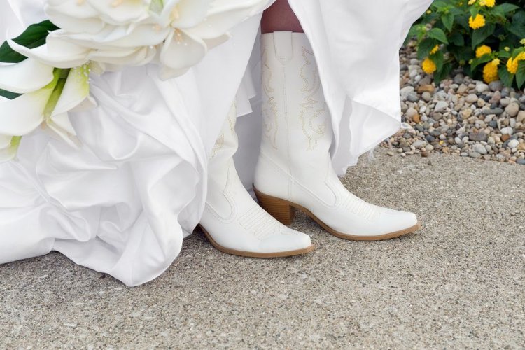 bride wearing white cowboy boots for her wedding