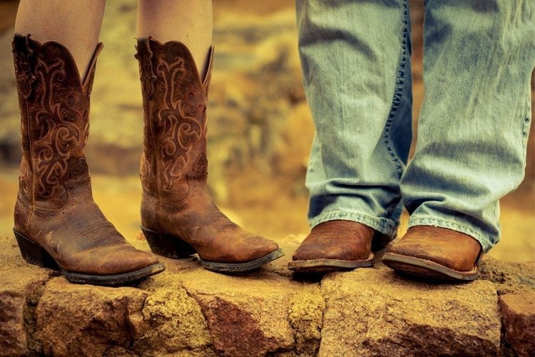 A couple wear cowboy boots