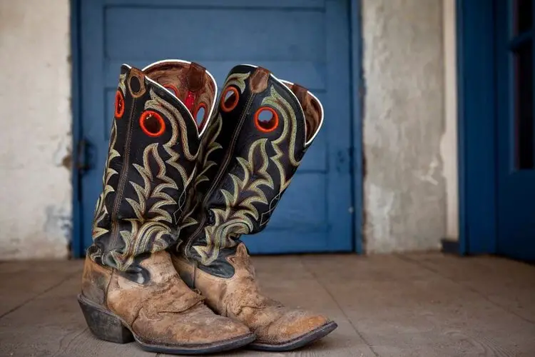 A pair of cowboy boots with stitching