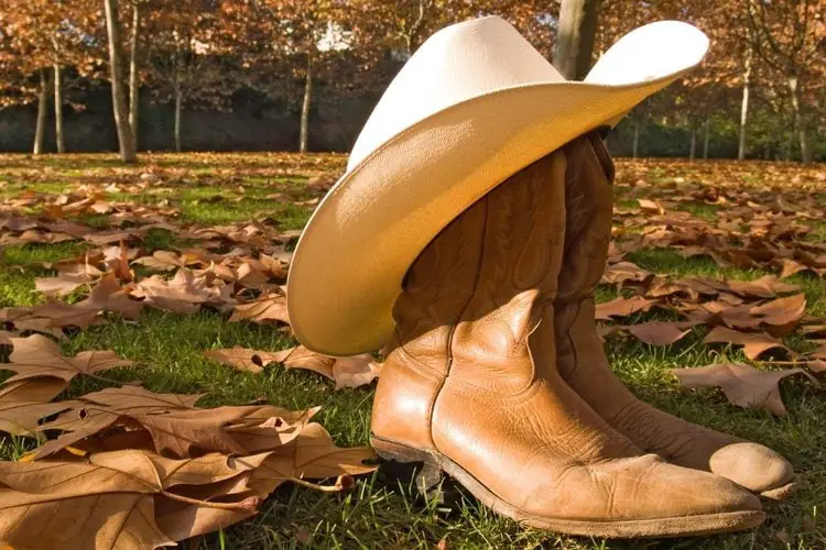 Cowboy boots wear cowboy hat on the yard
