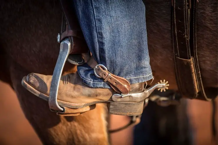 Men wear jeans and cowboy boots for riding