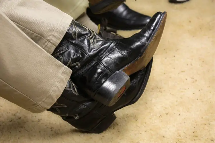 Men wear khakis with black lizard cowboy boots