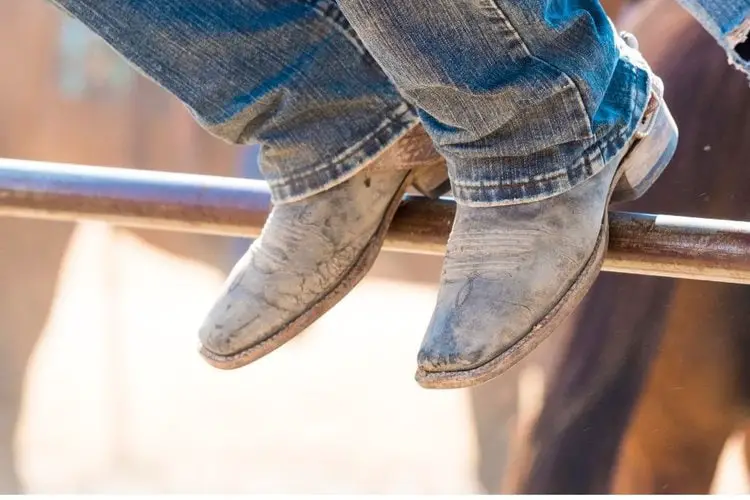 Men wear square toe cowboy boots sit on the fence