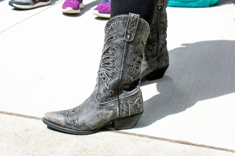 Women wear dark cowboy boots