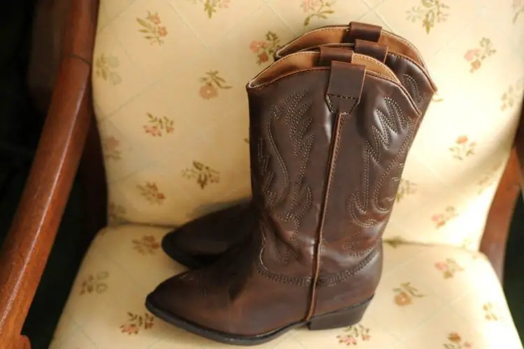 brown cowboy boots in chair
